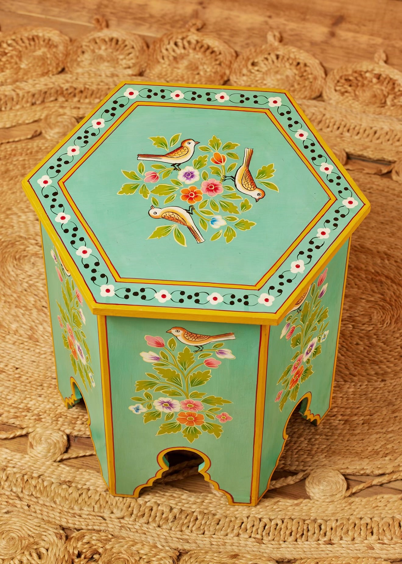 Top view of the smaller Chaman turquoise hexagonal table with hand-painted birds and flowers