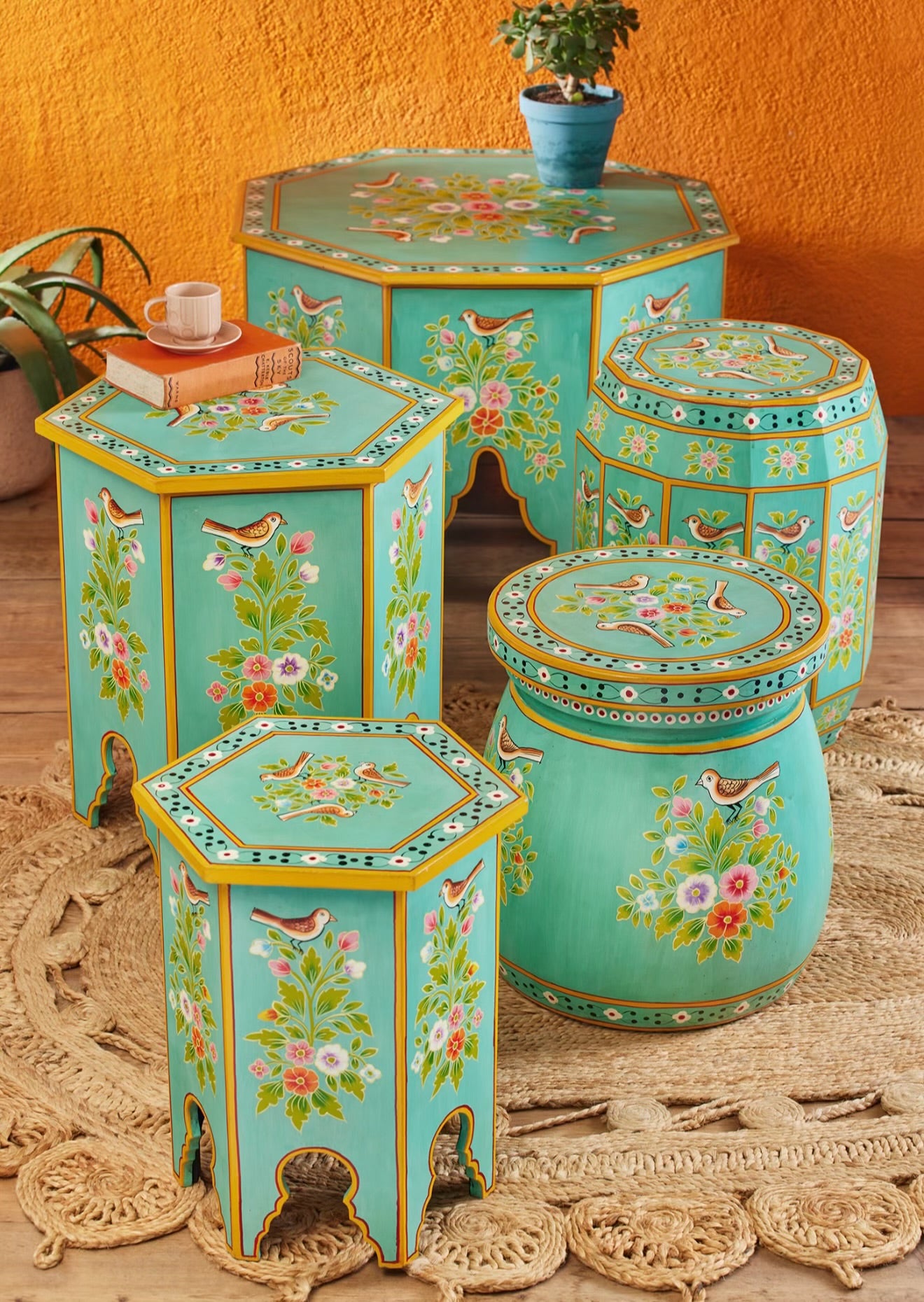 The Chaman Tables displayed with matching hand-painted turquoise floral furniture from RANG