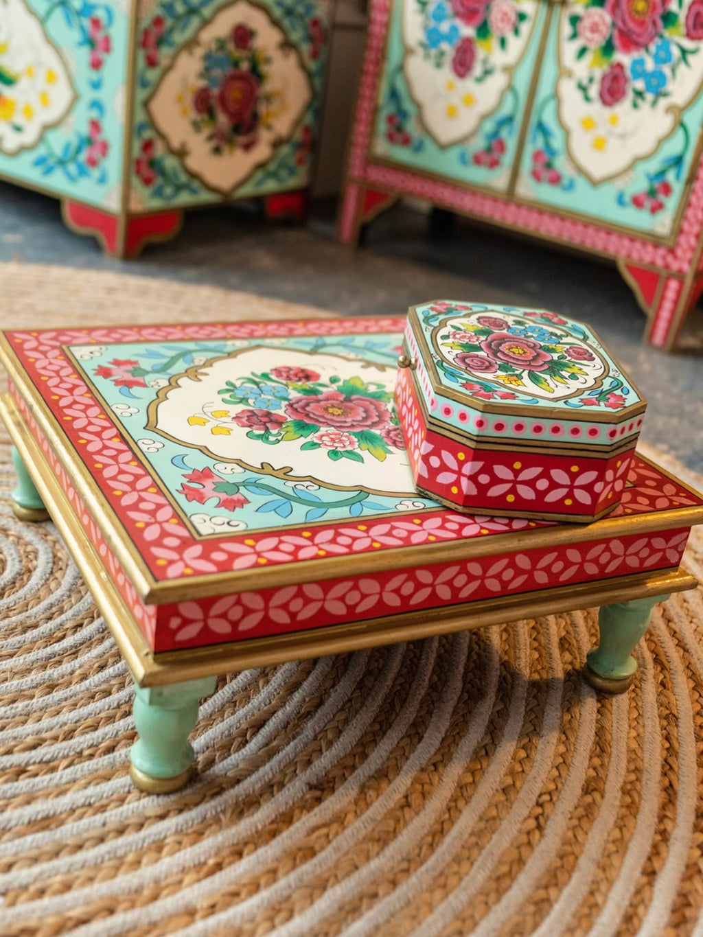 Close-up of The Gulbahar hand-painted floral chowki table with red and turquoise detailing