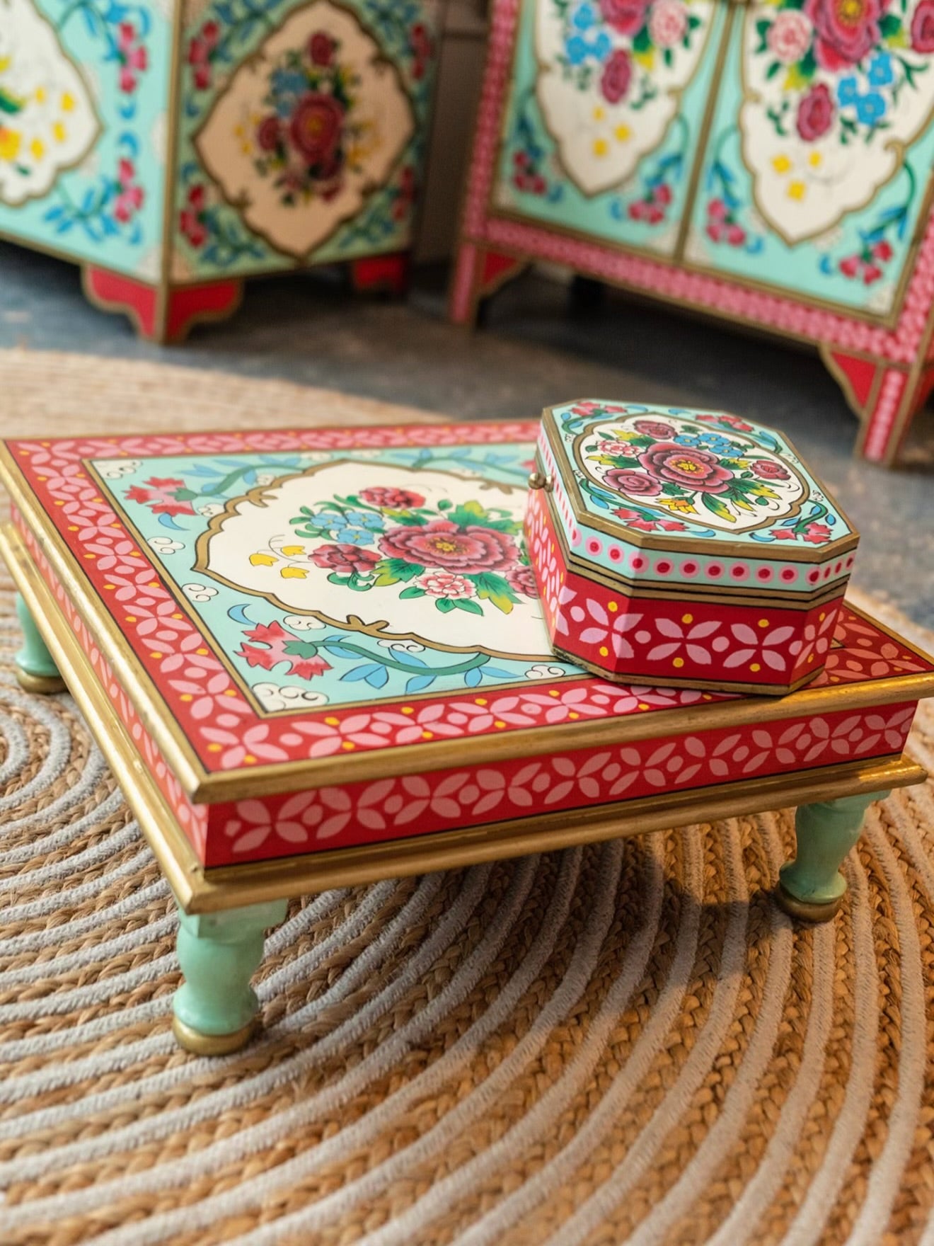 Close-up of The Gulbahar hand-painted floral chowki table with red and turquoise detailing