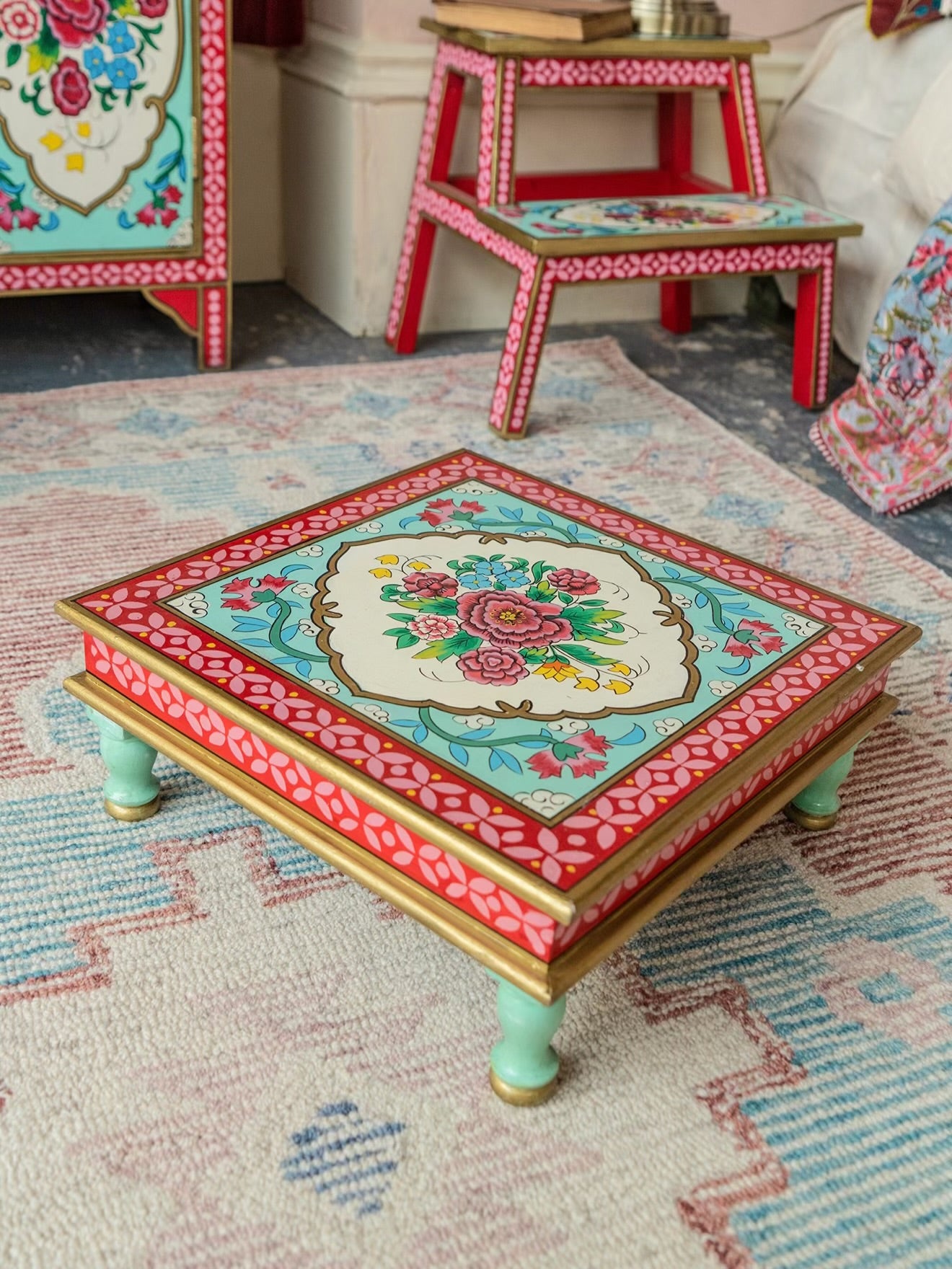 The Gulbahar low square hand-painted accent table with floral motifs and mint green legs