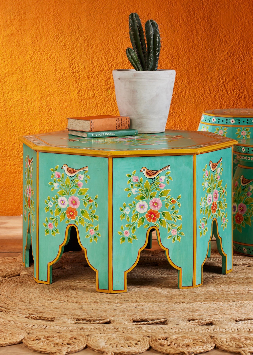 The Gulshan hand-painted octagonal coffee table in turquoise with floral and bird motifs
