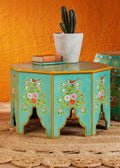 The Gulshan hand-painted octagonal coffee table in turquoise with floral and bird motifs