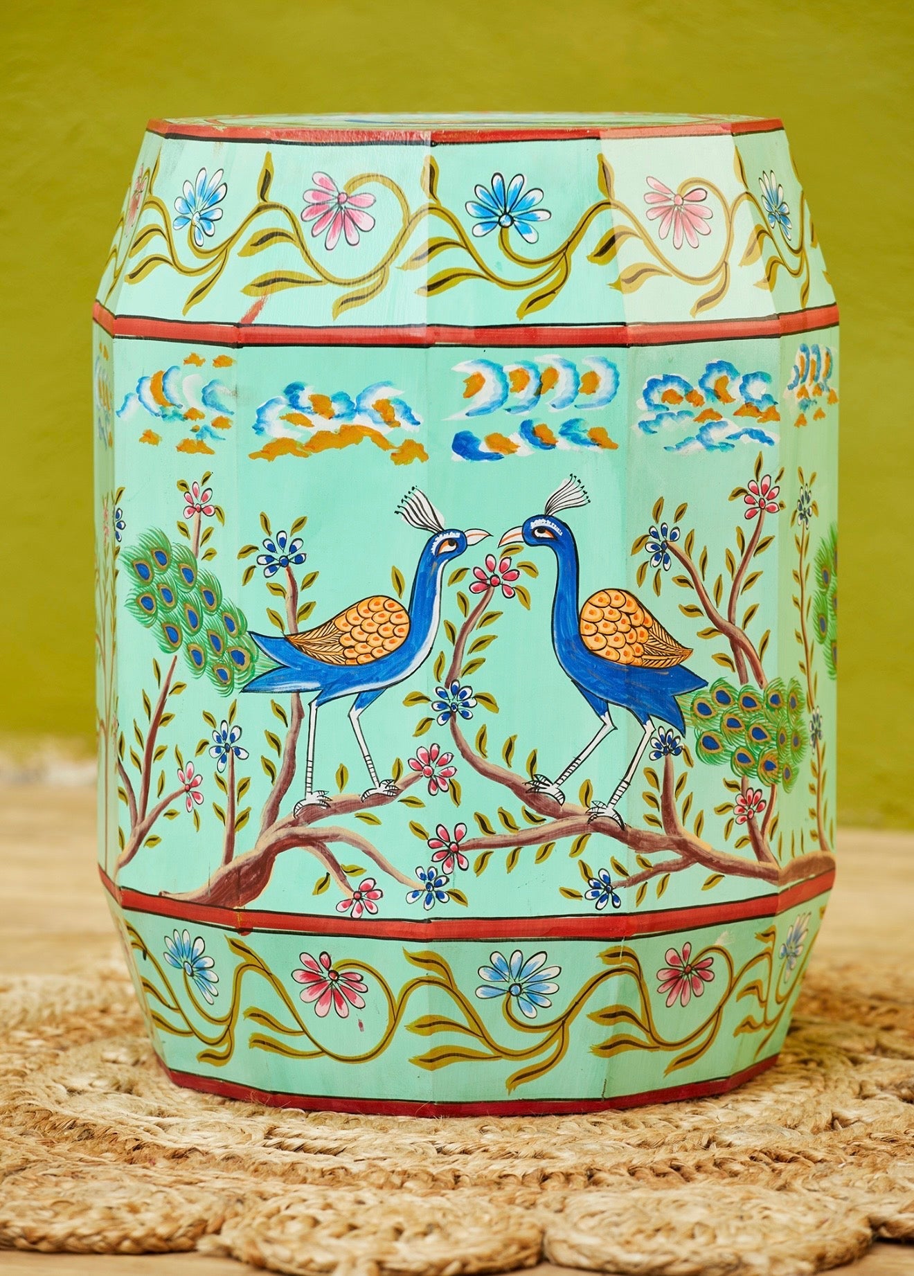 Front detail of the Morni turquoise hand-painted stool with two peacocks and floral vines