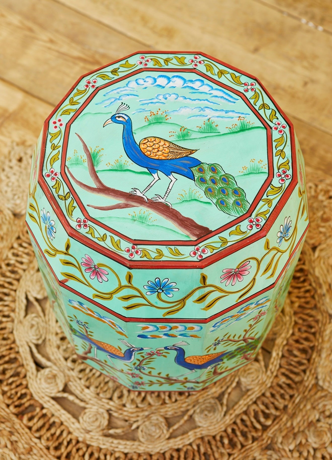 Top view of the Morni hand-painted peacock stool showing the octagonal peacock artwork