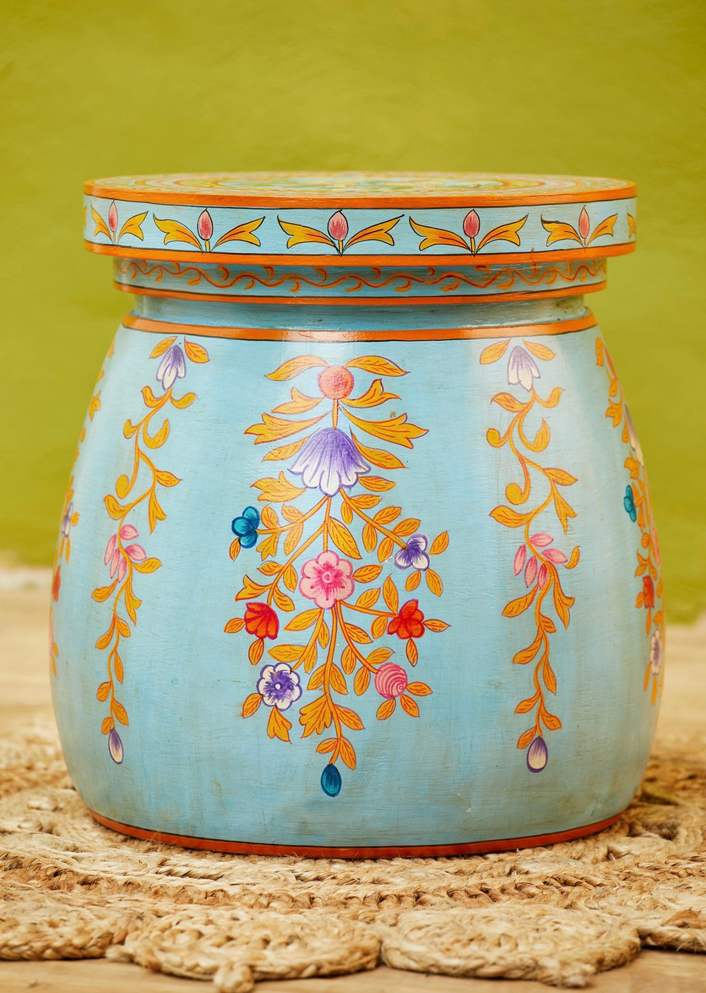 Front view of a hand-painted blue dome coffee table with floral motifs