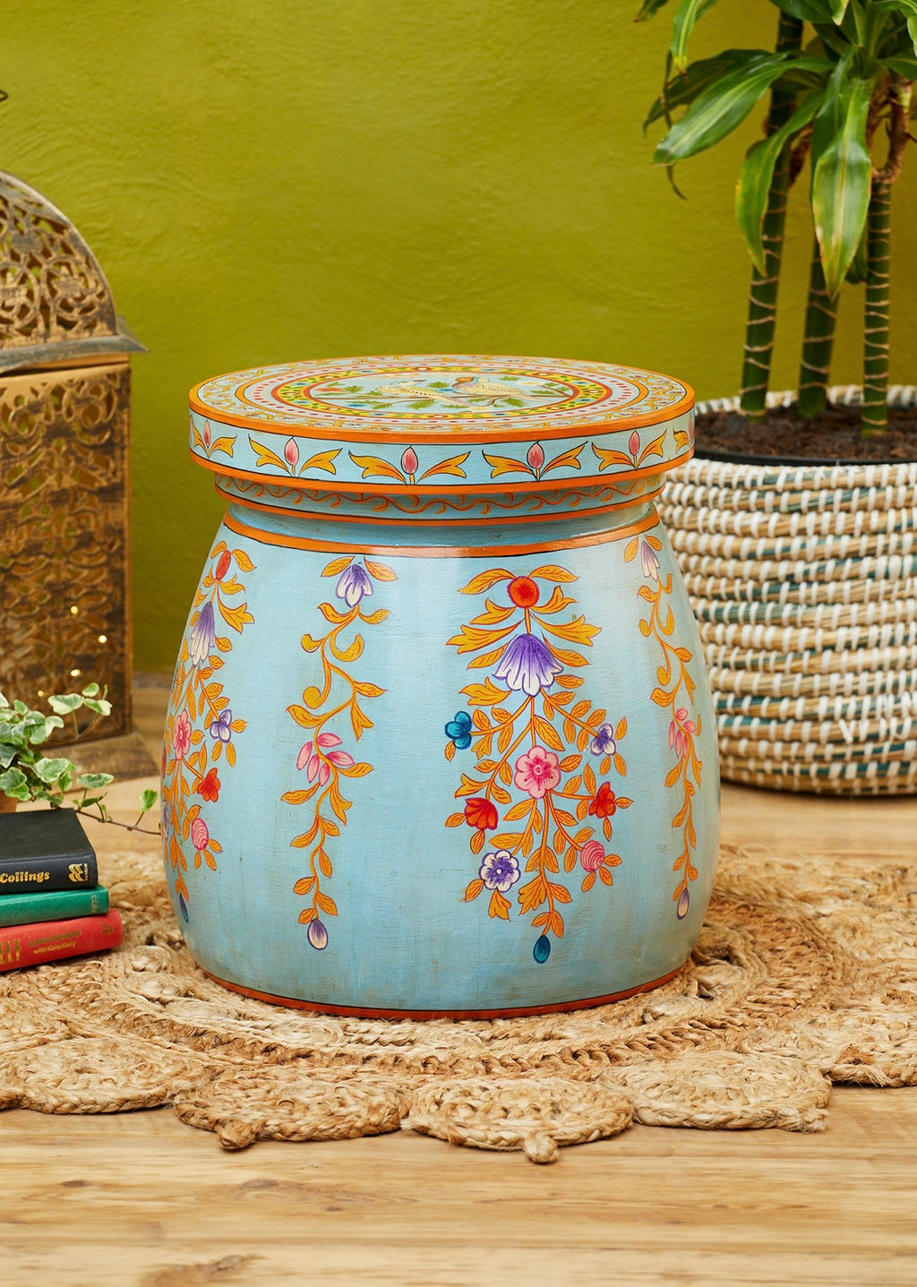 Hand-painted blue dome coffee table with floral motifs in a styled interior
