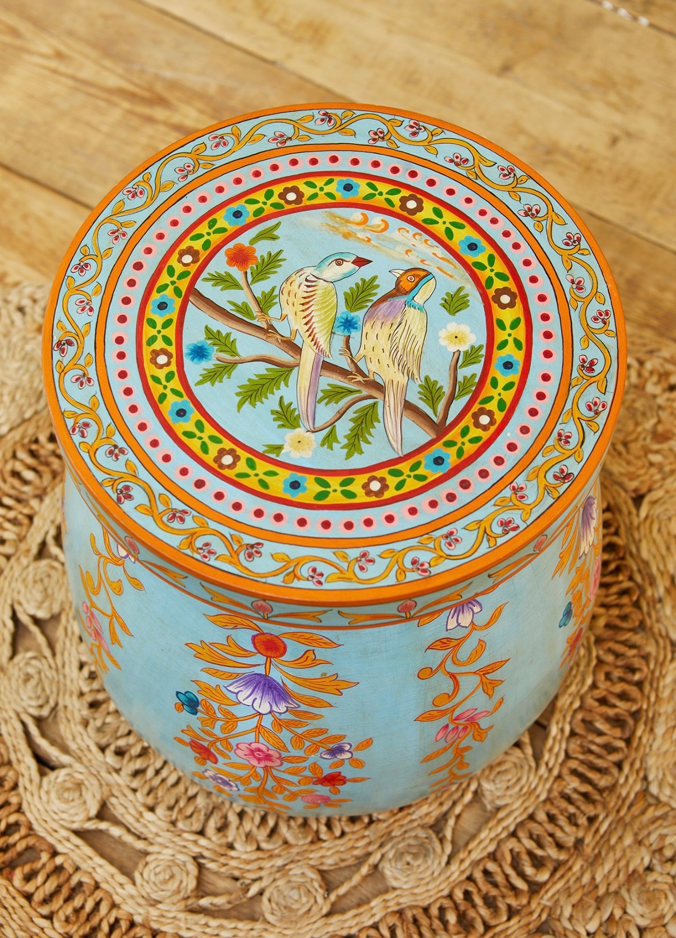 Top view of a hand-painted blue dome coffee table with bird and floral artwork