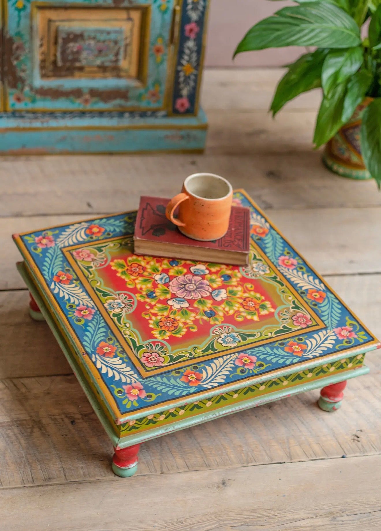 Hand-painted low square chowki table with blue, red and floral detailing
