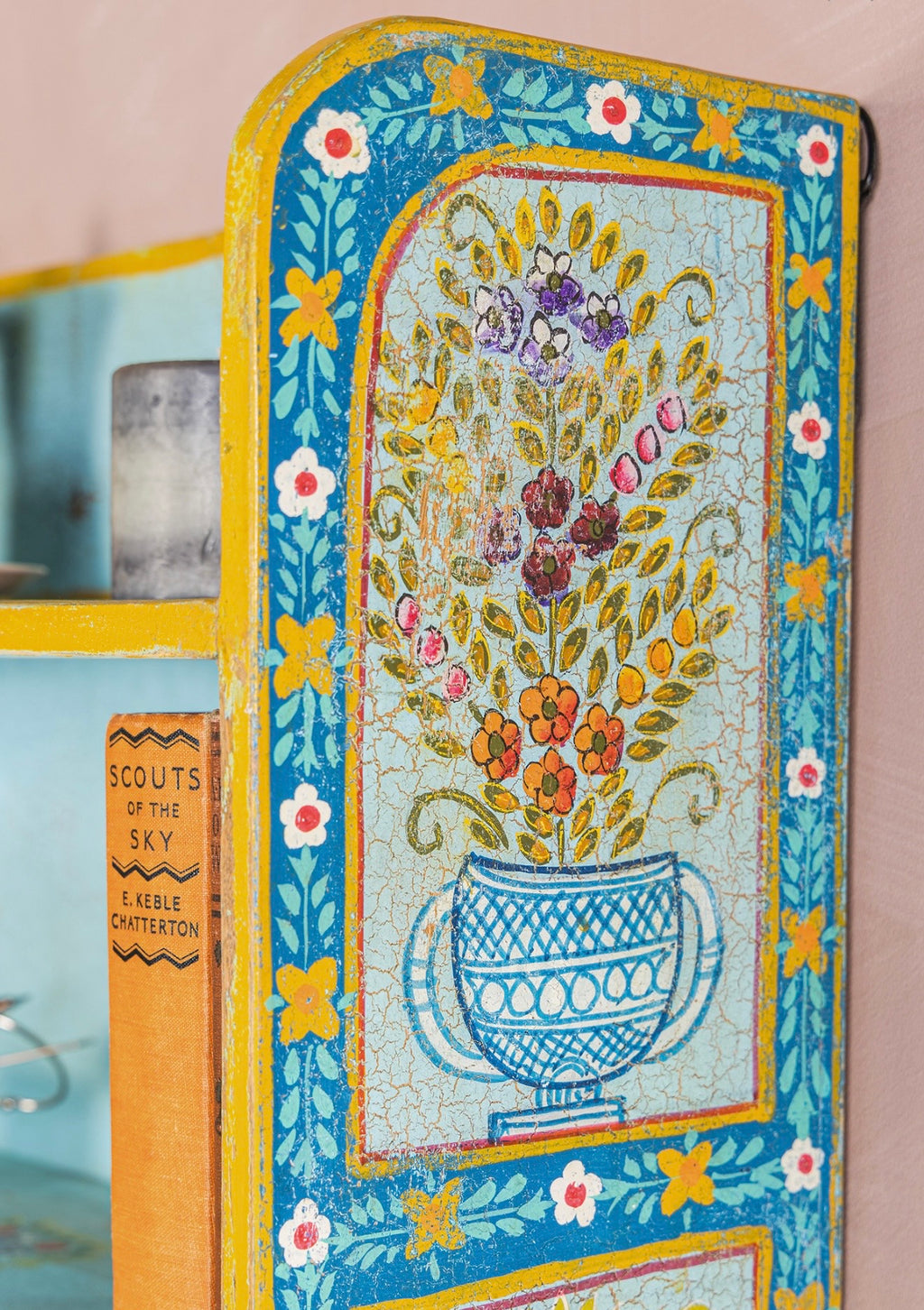Close-up of floral vase artwork and distressed crackle finish on The Aabshar Wall Shelf