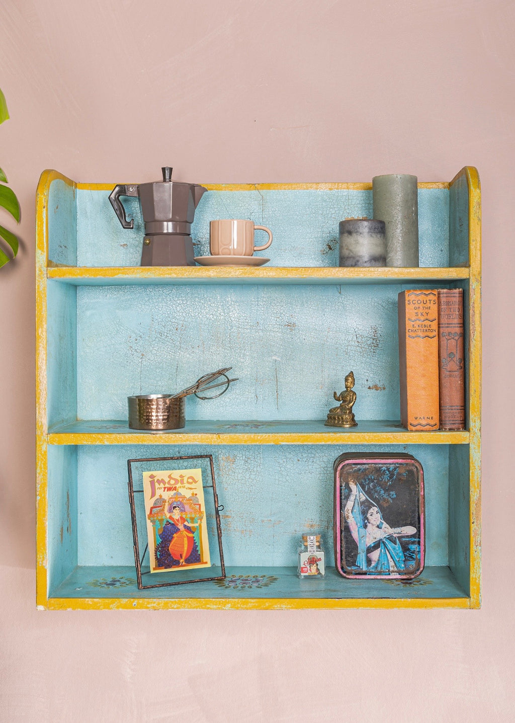 Front view of The Aabshar hand-painted turquoise wall shelf with yellow trim and distressed finish