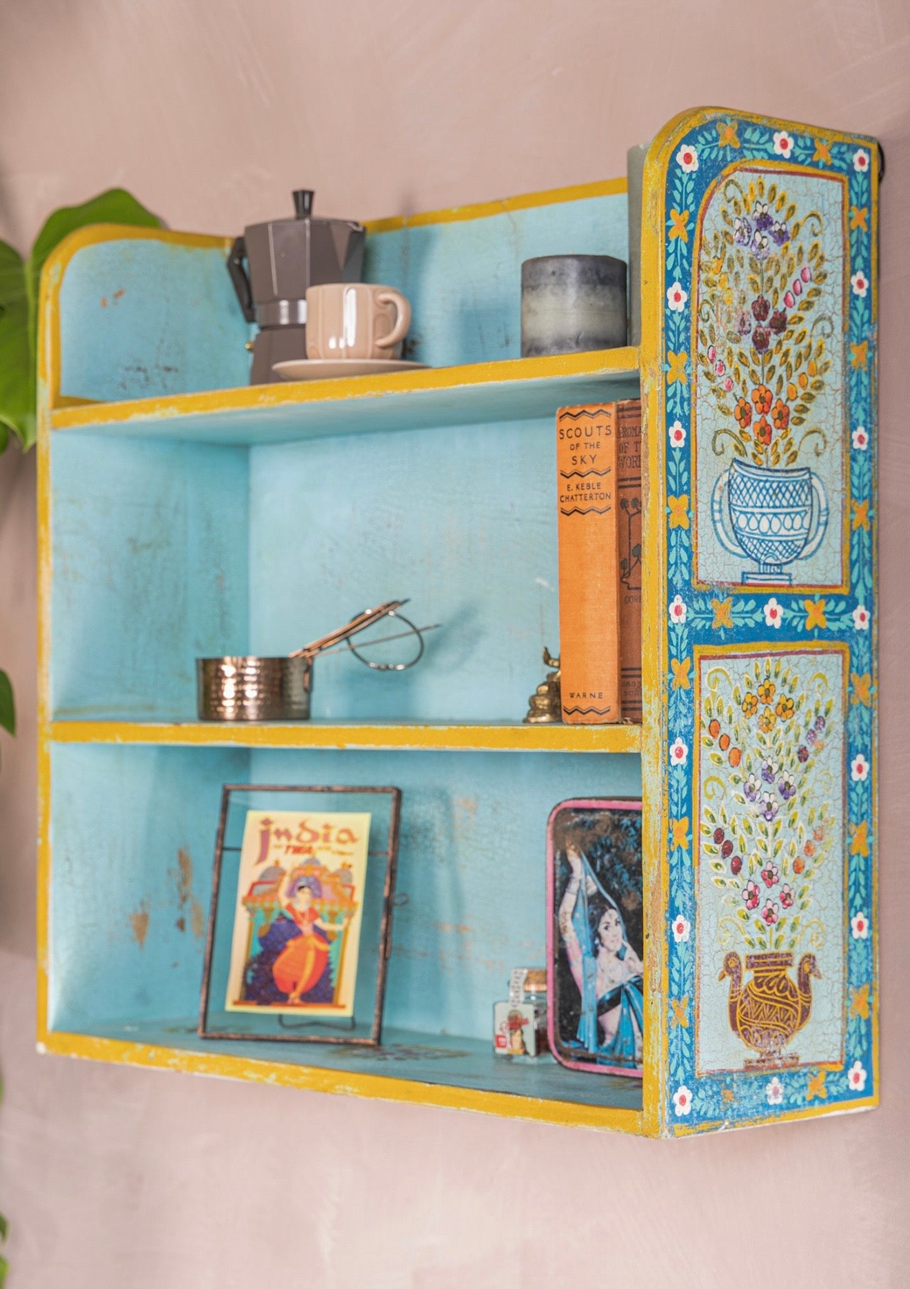 Side view of The Aabshar turquoise wall shelf with floral vase panels and yellow edging
