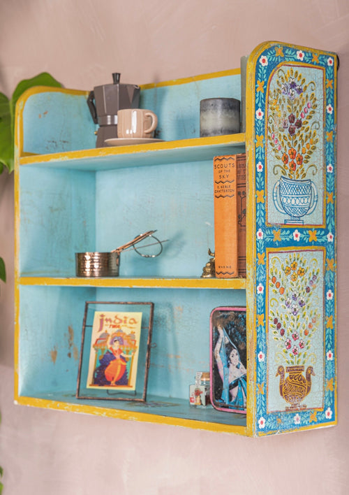 Side view of The Aabshar turquoise wall shelf with floral vase panels and yellow edging