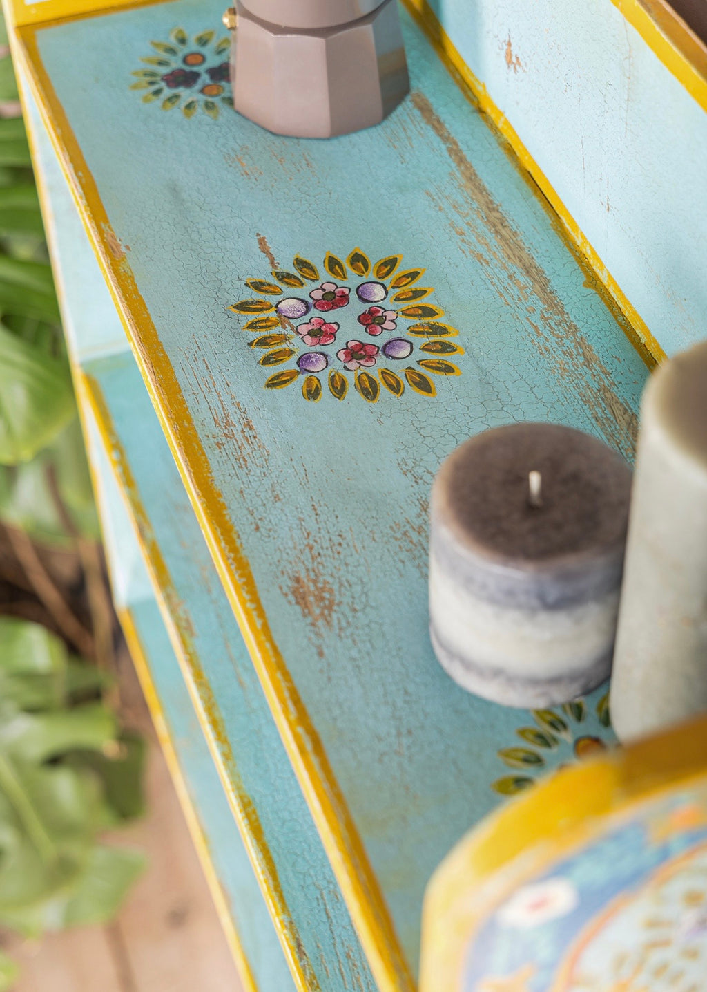 Close-up of The Aabshar turquoise shelf surface with floral medallions and distressed finish